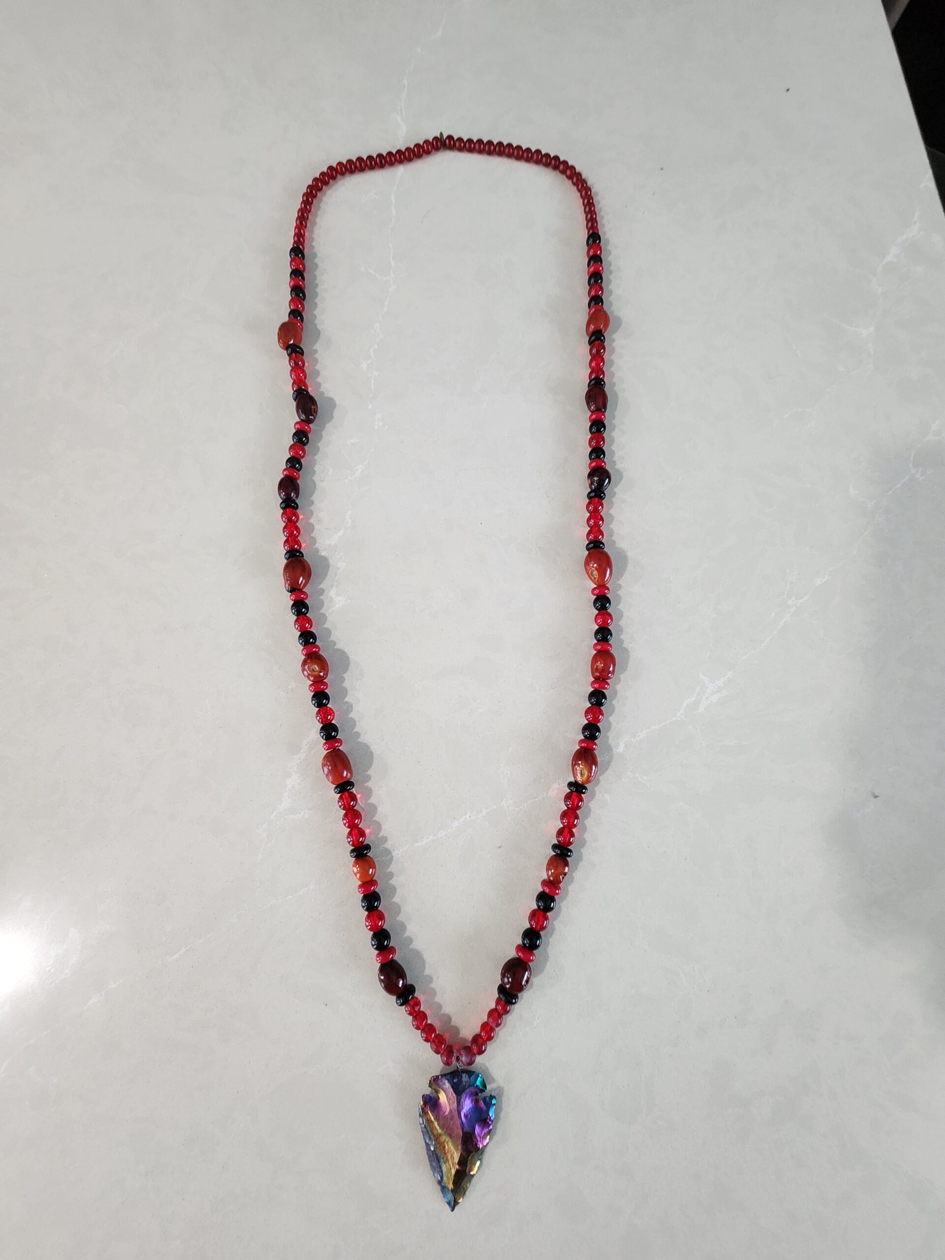 Red and Black Necklace with Iridescent Arrowhead Pendent